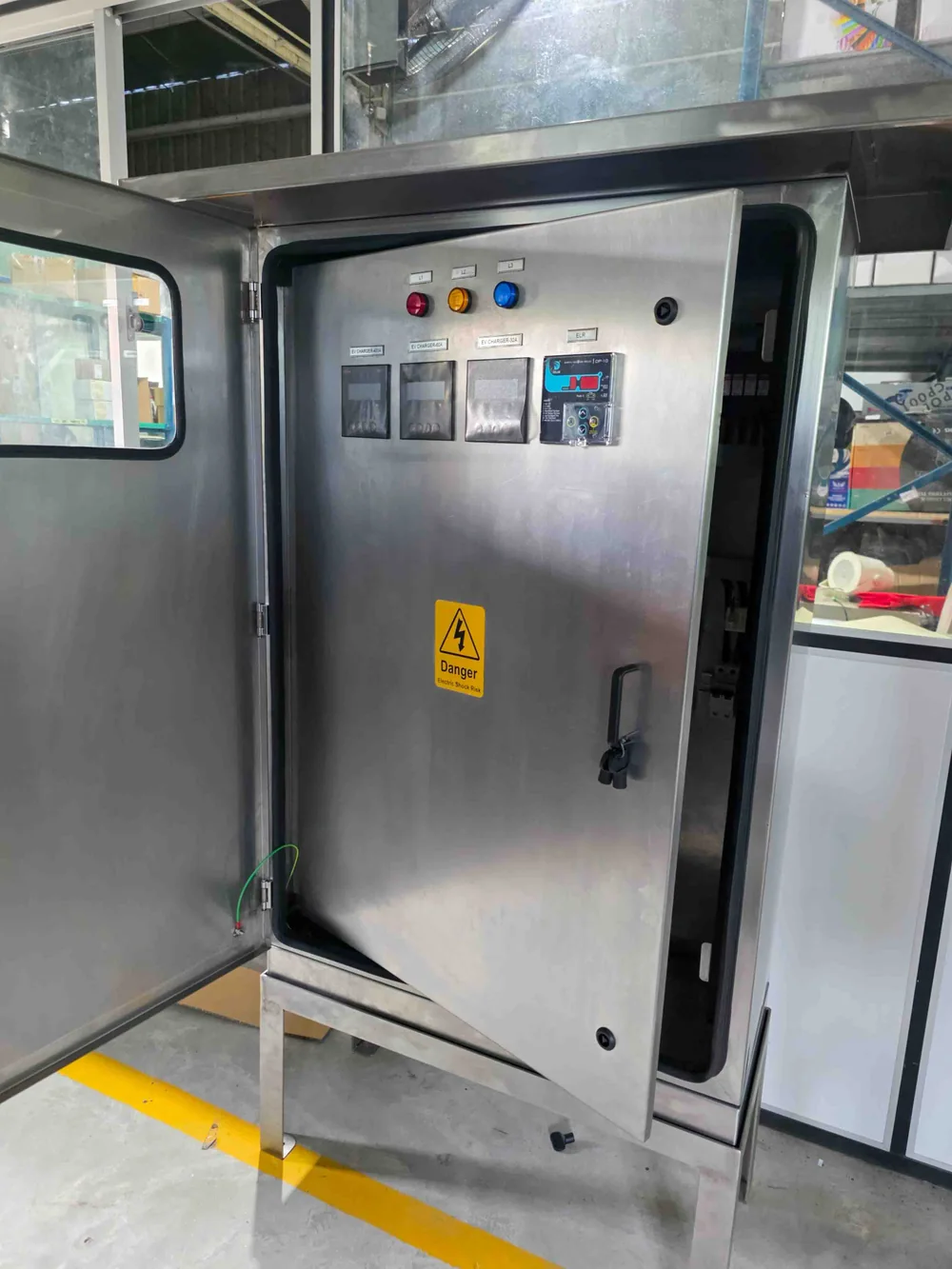 Stainless steel enclosure with panel components under assembly